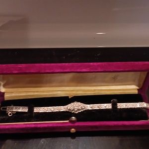 Antique 10k wg filigree bracelet with 15 old-mine round diamonds.